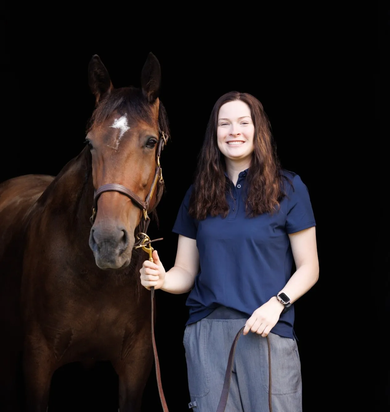Portrait of Emma with a bay horse
